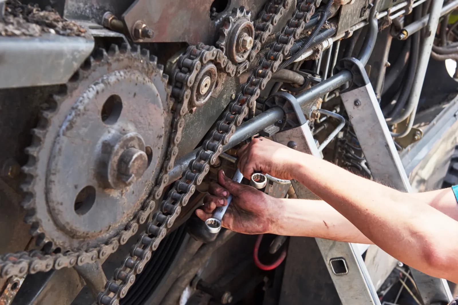 combine-machine-service-mechanic-repairing-motor-outdoors